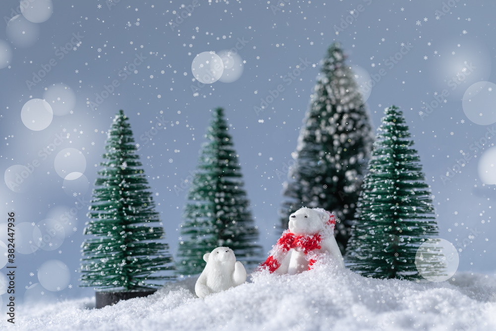 Cute white bears on snow in the forest at Christmas night