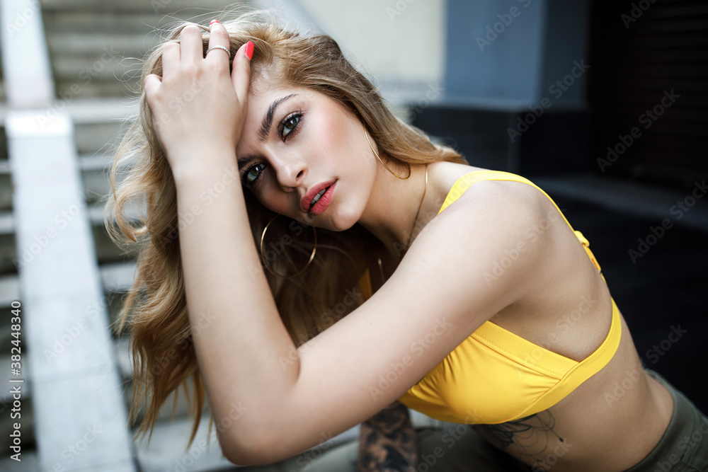 Street fashion summer portrait of beautiful woman sitting on stairs Street fashion summer portrait of beautiful woman sitting on stairs