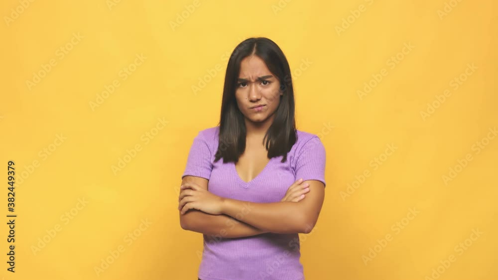 Young mixed race indian woman frowning face in displeasure, keeps arms folded Young mixed race indian woman frowning face in displeasure, keeps arms folded
