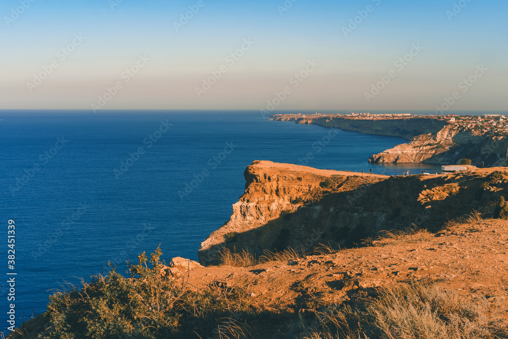 Summer seascape with Fiolent rocks formation on the coast of Sevastopol. view on cape in the sea, clear azure water, calm hot day. 