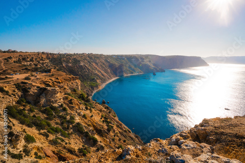 Summer seascape with Fiolent rocks formation on the coast of Sevastopol. view on cape in the sea, clear azure water, calm hot day. 