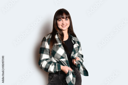 Positive person portrait young smiling girl at studio happy face toothed smile looking at the camera.