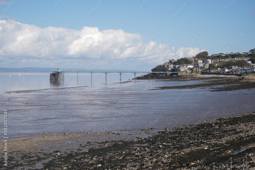 Panoramic photo of Clevedon Pier in somerset showing iron structure against blue sky