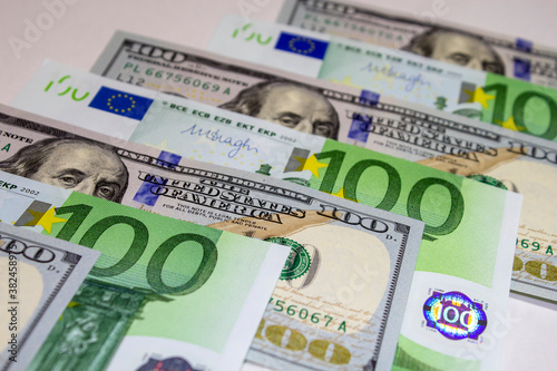 One hundred US dollars and 100 new Euros banknotes. Macro. Currency pair