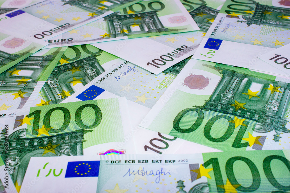 Many one hundred Euro banknotes on the table. 100 euro banknotes