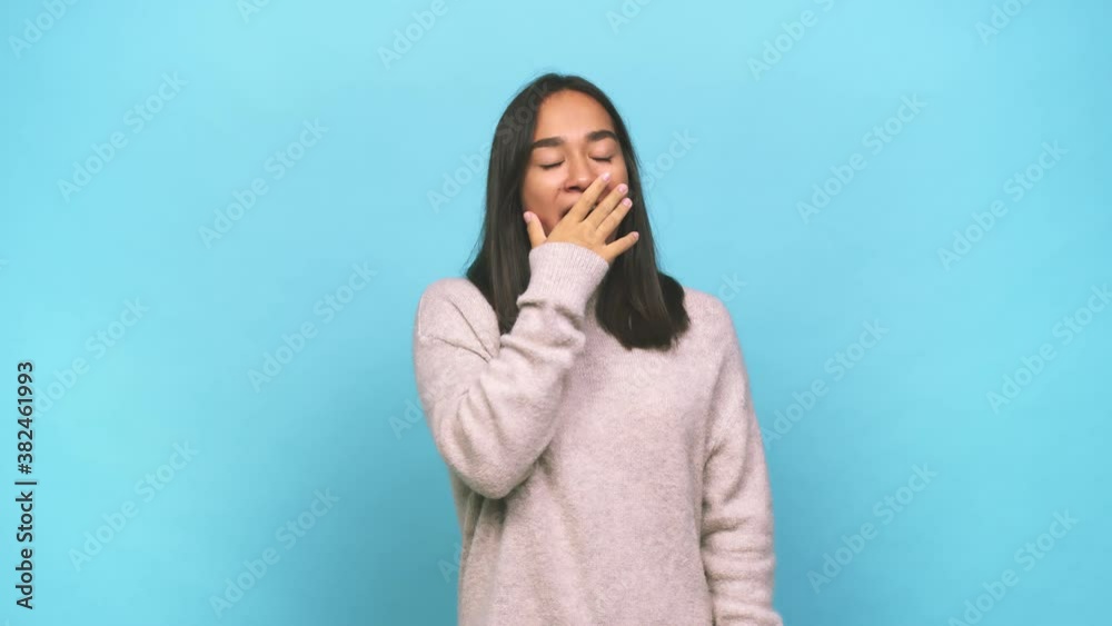 Young mixed race indian woman yawning showing a tired gesture covering mouth with hand Young mixed race indian woman yawning showing a tired gesture covering mouth with hand