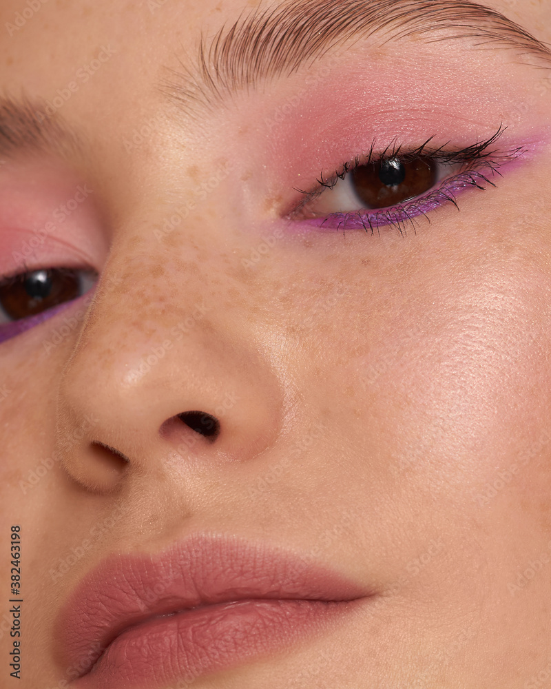 Fototapeta premium Close-up macro of a beautiful female eye with a perfect eyebrow shape. Clean skin, trendy natural makeup. Good vision