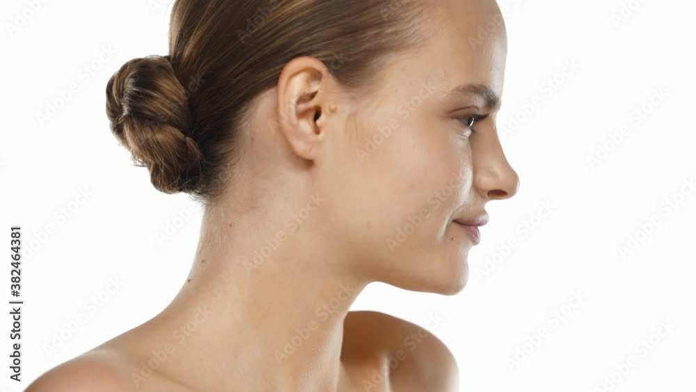 Side view of young woman turning and winking isolated on white Side view of young woman turning and winking isolated on white