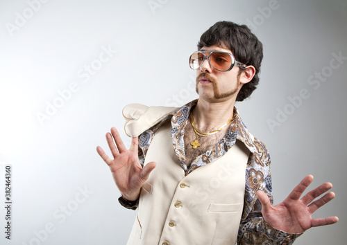 Εκτύπωση καμβά 1970s retro man in a white leisure suite and sunglasses looking surprised