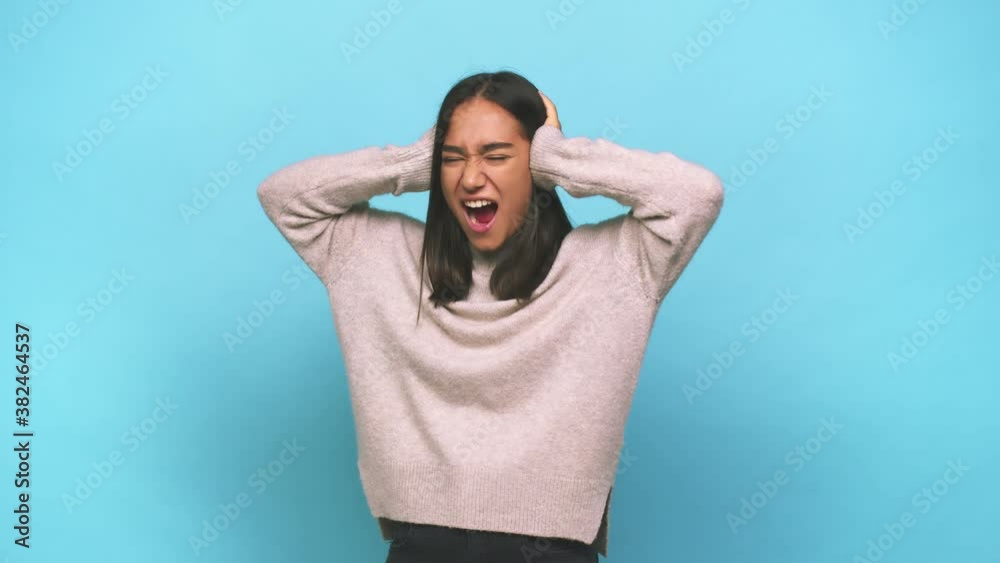 Young mixed race indian woman covering ears with hands trying not to hear too loud sound Young mixed race indian woman covering ears with hands trying not to hear too loud sound