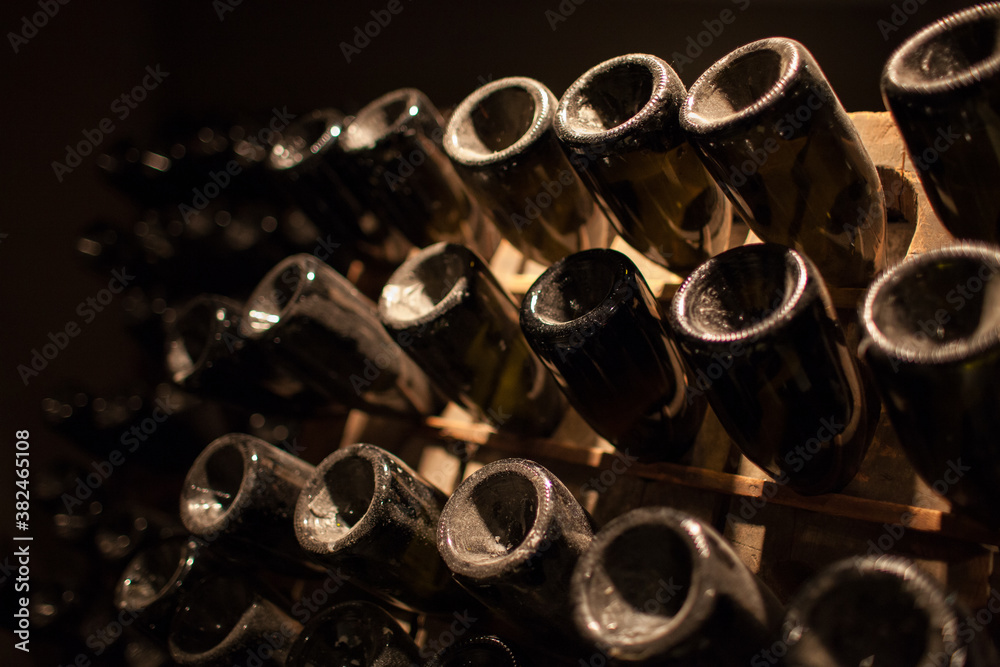 old wine bottles in a rack with dust and grime
