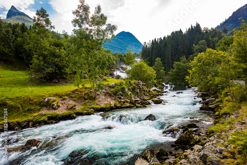 View of the river Geirangerelvi and the waterfall Storfossen in Geiranger, Norway. photo