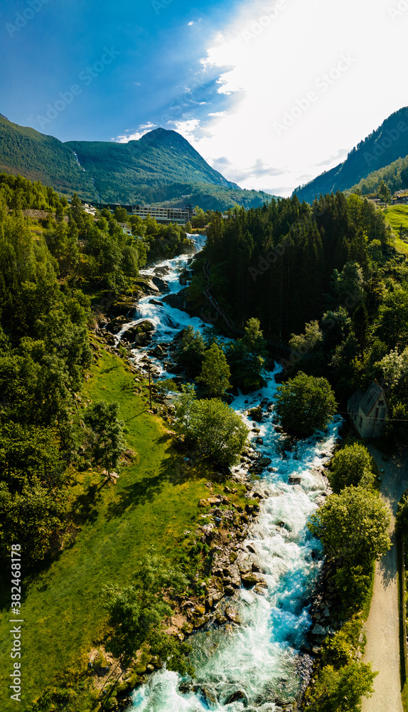View of the river Geirangerelvi and the waterfall Storfossen in Geiranger, Norway.
