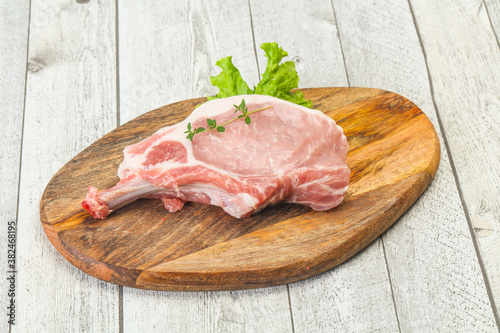 Raw pork bone steak over wooden