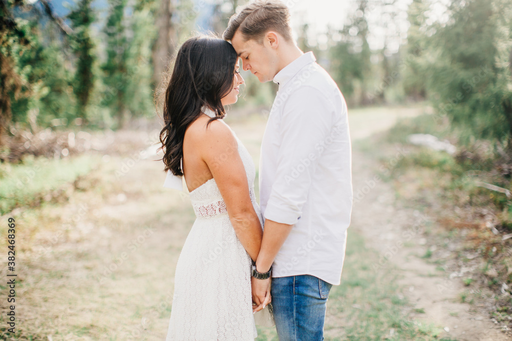 Couple laugh and embrace in forest Couple laugh and embrace in forest