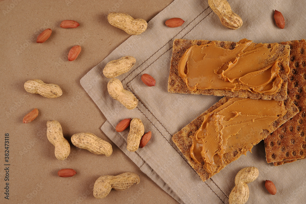 Peanut butter and peanut crispbreads on a linen napkin Peanut butter and peanut crispbreads on a linen napkin