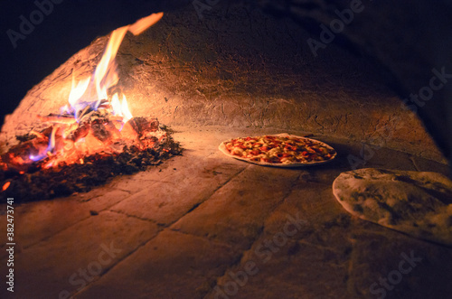 Veggie pizzas in firewood oven photo