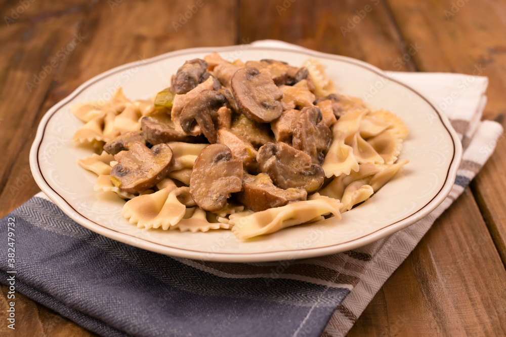 Butterfly pasta with mushrooms and parmesan sauce. Typical Italian cuisine from the south. High quality photo. Copy space. Butterfly pasta with mushrooms and parmesan sauce. Typical Italian cuisine from the south. High quality photo. Copy space.