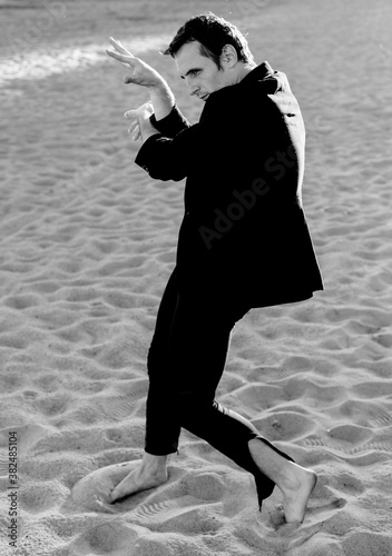 people dancing on the sand photo