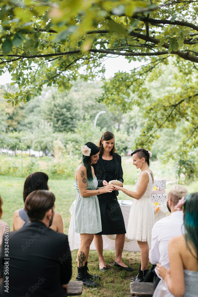 Lesbian couple exchanging rings