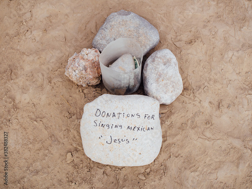 Donation jar for panhandler on the United States Mexico border