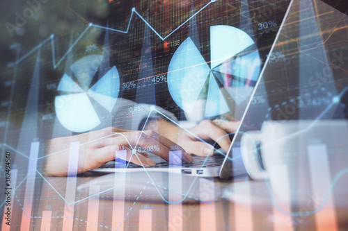 Double exposure of woman hands typing on computer and forex chart hologram drawing. Stock market invest concept.