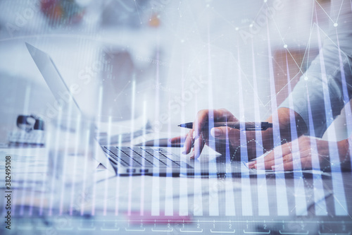 Double exposure of woman hands typing on computer and forex chart hologram drawing. Stock market invest concept.