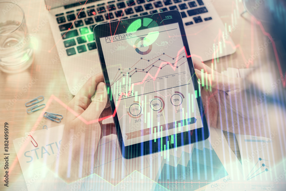 Double exposure of man's hands holding and using a digital device and forex graph drawing. Financial market concept. Double exposure of man's hands holding and using a digital device and forex graph drawing. Financial market concept.