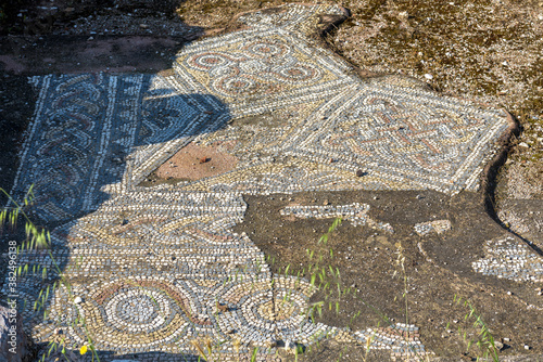 Ancient Greek mosaic in Library of Hadrian, Athens, Greece. Beautiful patterned floor in old ruins background. photo