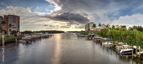 Boats docked in a harbor along the Cocohatchee River in Bonita Springs photo