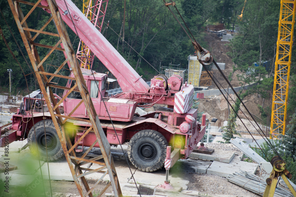 Tower crane at a construction site in the city Tower crane at a construction site in the city
