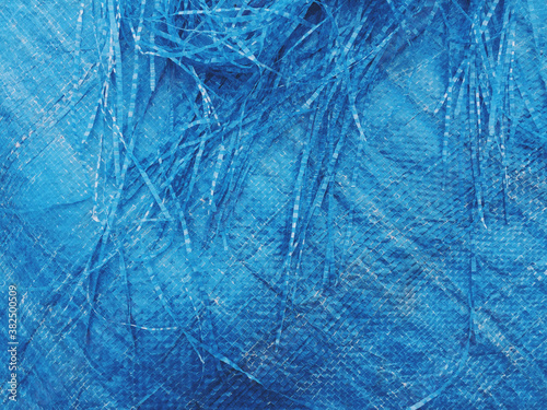 Detail of torn blue tarpaulin photo