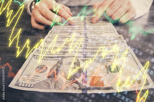 Multi exposure of forex graph drawing hologram and USA dollars bills and man hands. Technical Analysis concept.