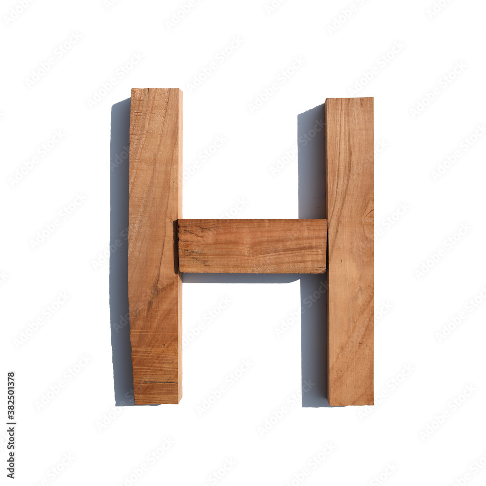 The letter H made of wood blocks on a white background board The letter H made of wood blocks on a white background board