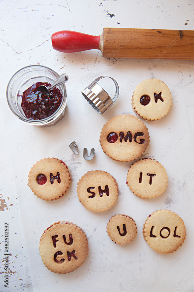 Shortbread biscuits / cookies filled with jam and buttercream spelling