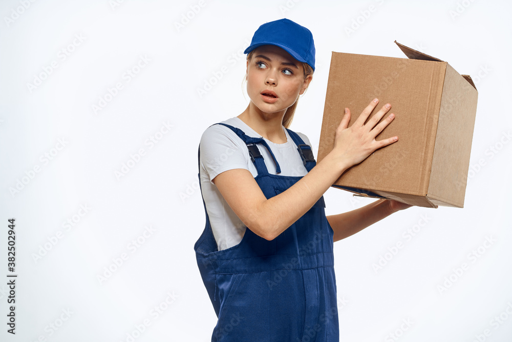 Woman working uniform box in hands packing service light background Woman working uniform box in hands packing service light background