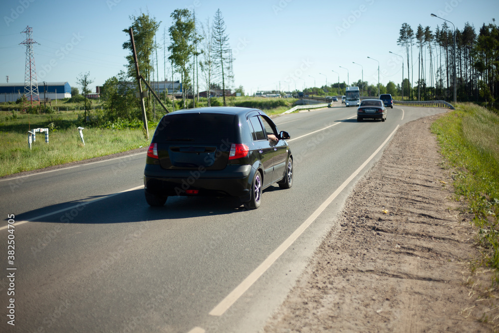 The car drives along the road. Country road. 