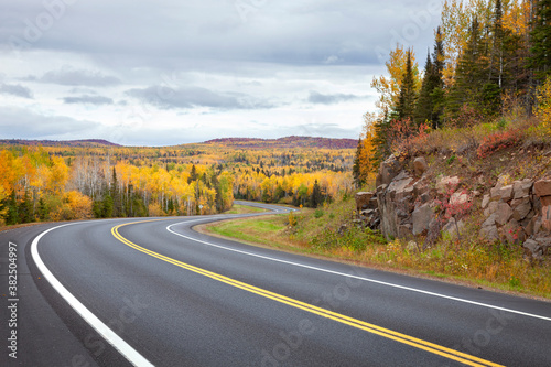 Curving highway and colorful trees in northern Minnesota on a autumn day