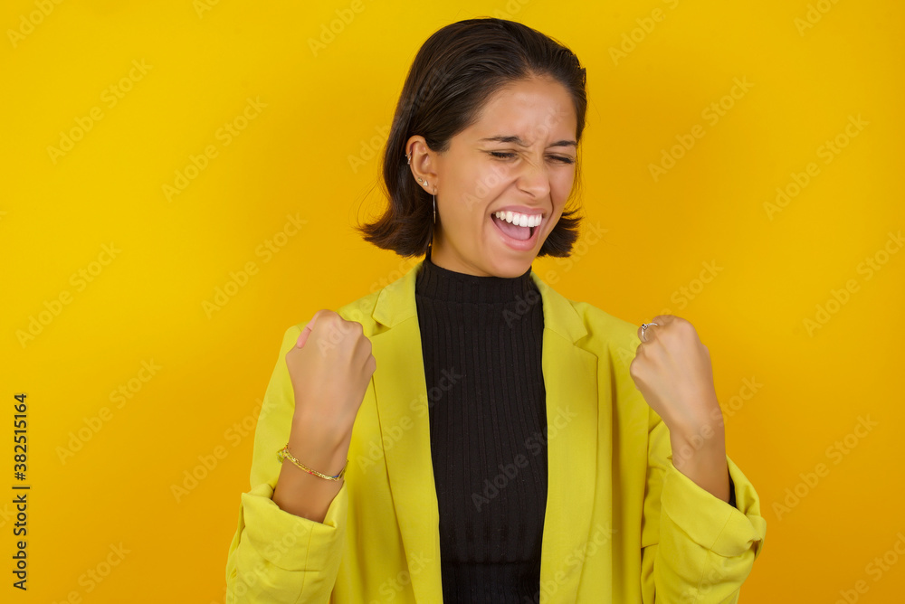 Φωτογραφία Young hispanic businesswoman wearing casual turtleneck sweater and jacket celebrating surprised and amazed for success with arms raised and eyes closed