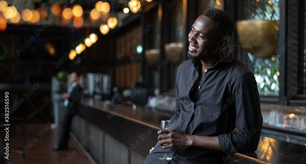 Portrait of confident African American businessman at nightclub.
