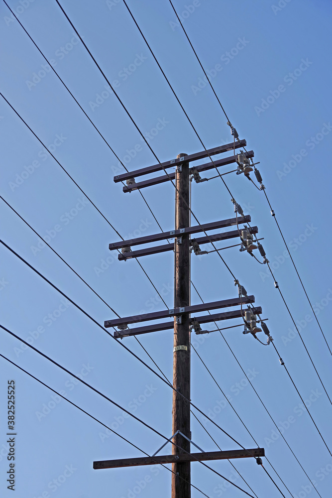 Low angle close view of the upper part of an Electricity Distribution Pylon with its cables and power lines Low angle close view of the upper part of an Electricity Distribution Pylon with its cables and power lines