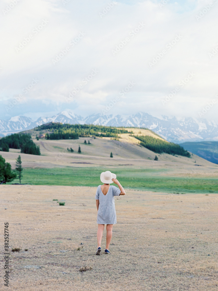 Unrecognizable woman walking in plain Unrecognizable woman walking in plain