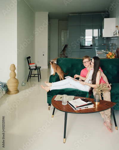 Couple sitting on sofa at home photo