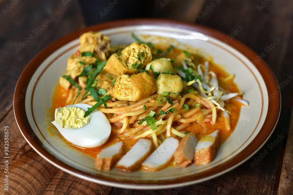 Curry noodle in a plate. Famous food called Mee Kari in malaysia. Noodle in a chicken curry gravy Curry noodle in a plate. Famous food called Mee Kari in malaysia. Noodle in a chicken curry gravy