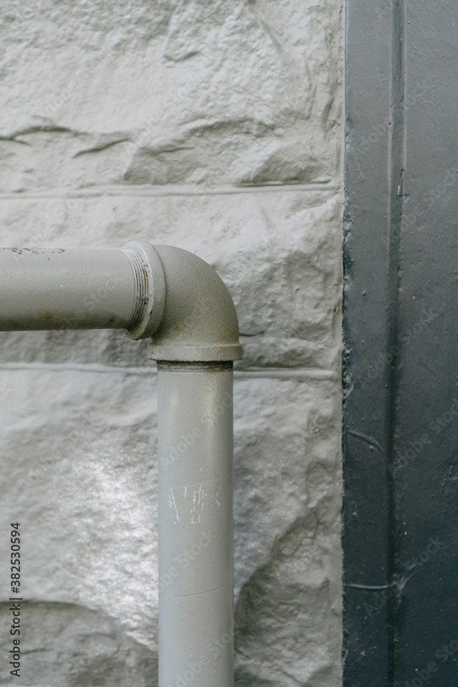 Close up of utility pipe against building wall Close up of utility pipe against building wall