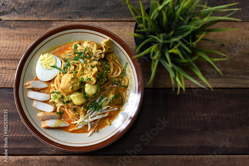 Curry noodle in a plate. Famous food called Mee Kari in malaysia. Noodle in a chicken curry gravy