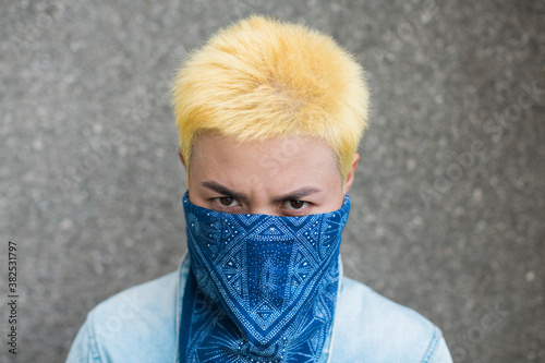 young asian woman covered face with blue headscarf photo