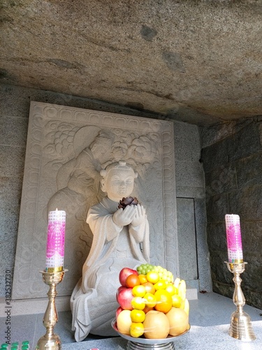 a Buddha stone statue in the mountains photo