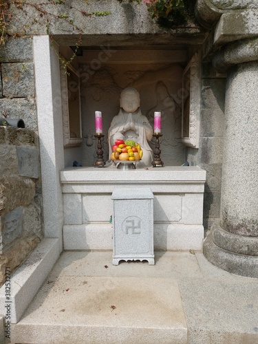 a Buddha stone statue in the mountains photo