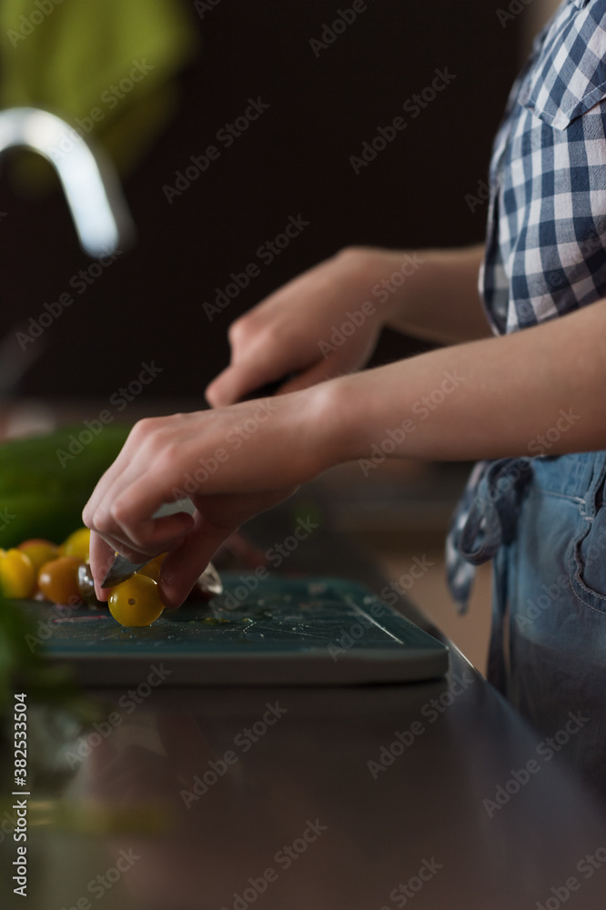Unrecognizable woman cutting tomatoes Unrecognizable woman cutting tomatoes